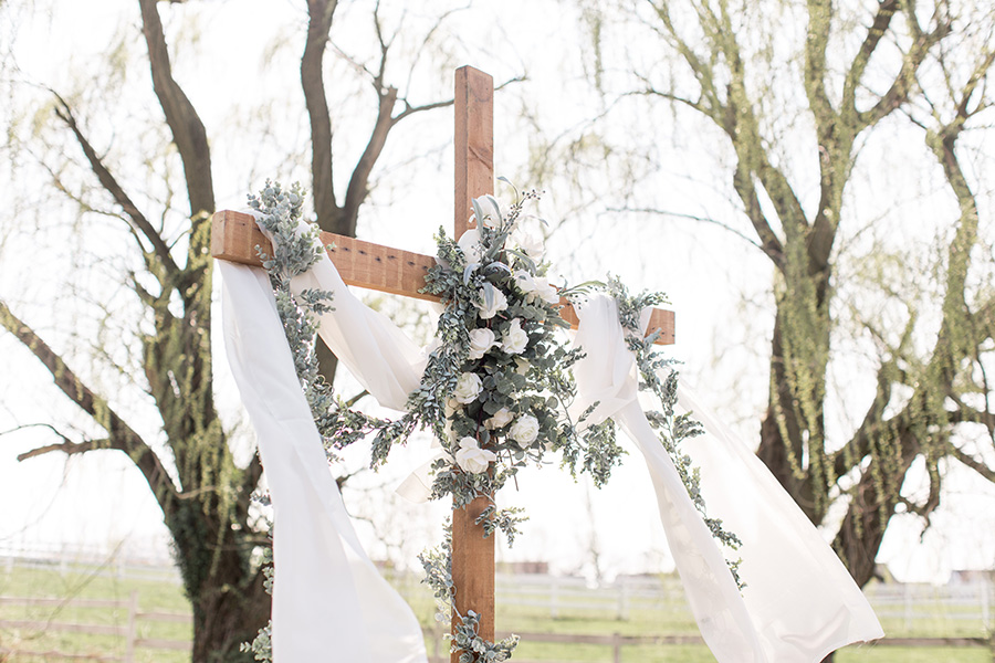 country ceremony cross at the wedding altar