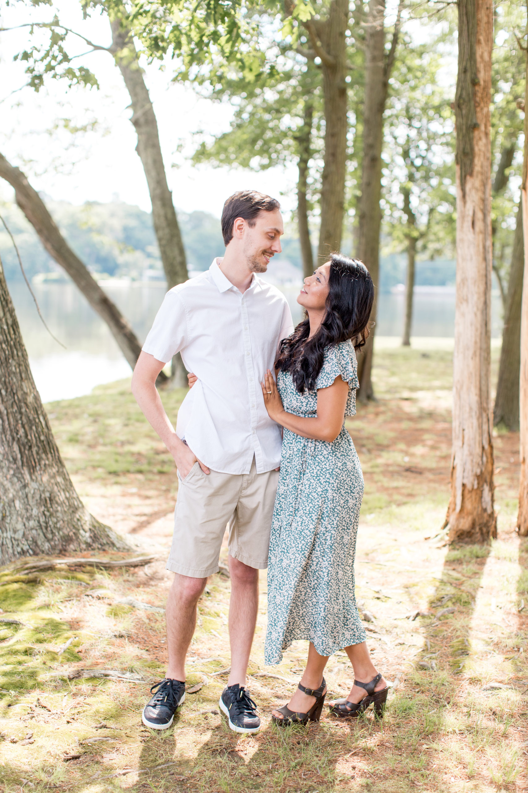 couple poses for engagement portraits at piney point on sunset lake
