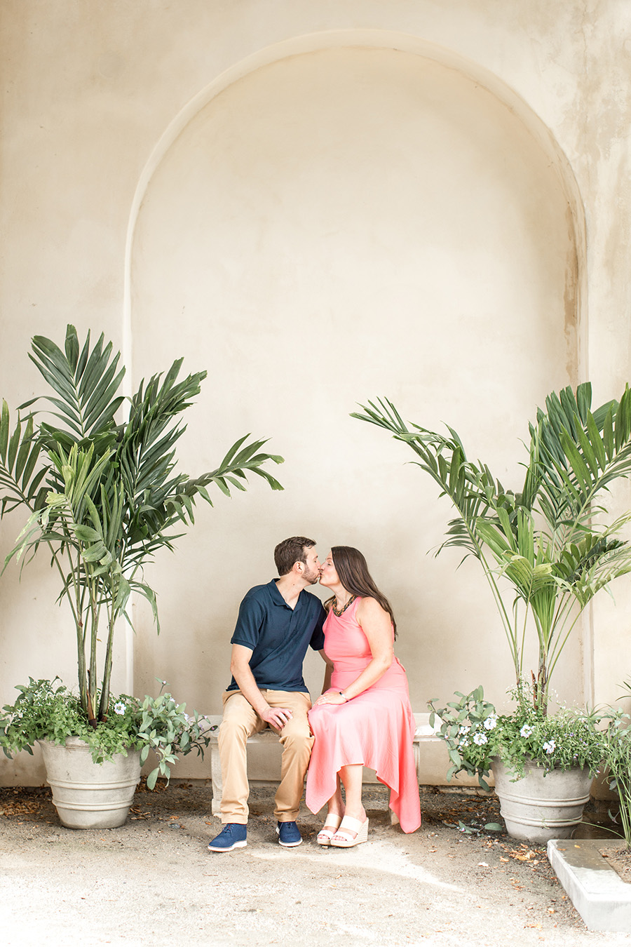 couple give each other kiss at longwood gardens summer engagement session