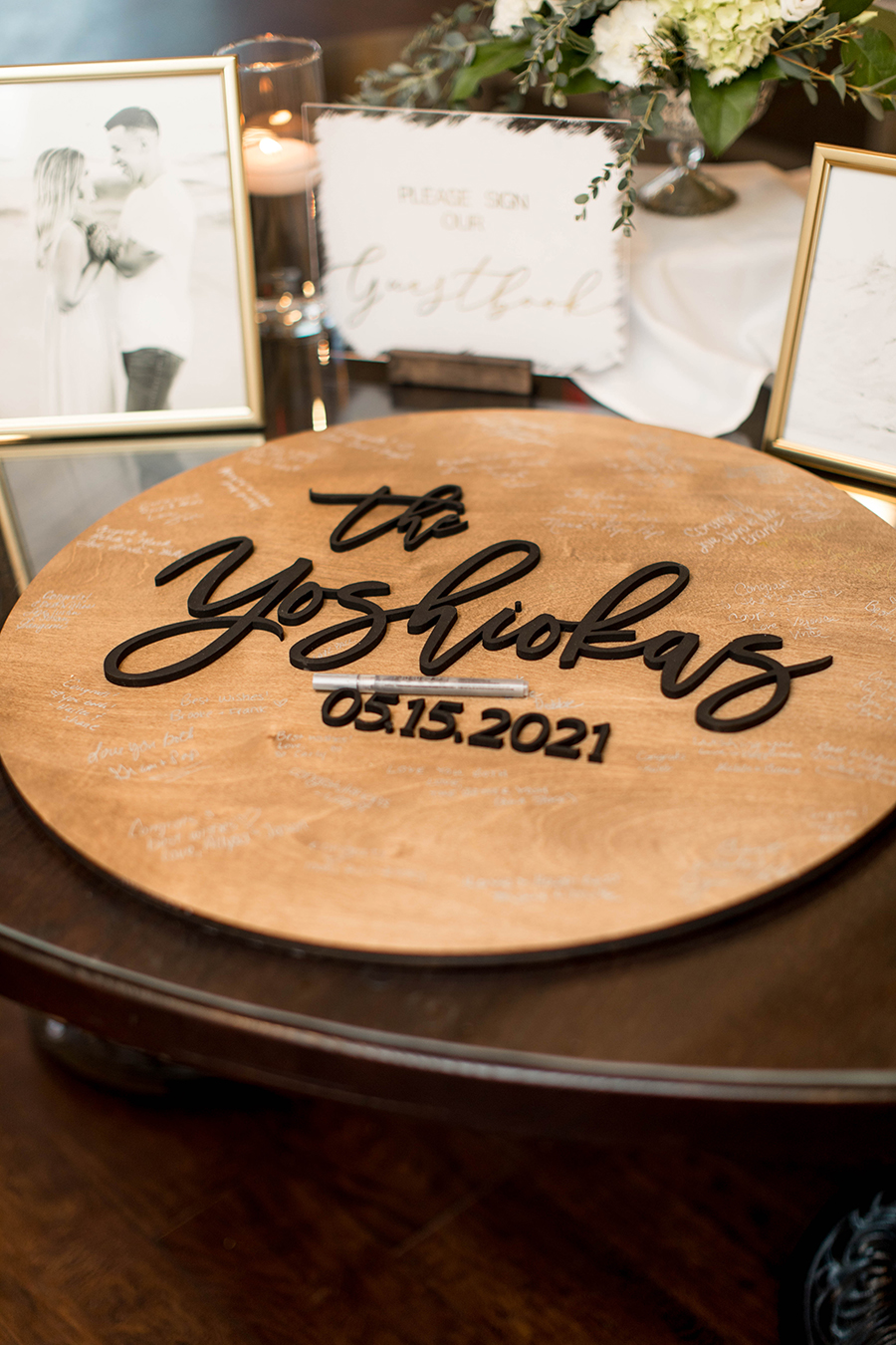 wooden guestbook sign with the couple's name and wedding date 